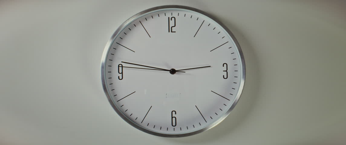 Close Up of Wall Clock with Minimalist Design with Moving Clock Hands Showing Precise Time, Hanging on the White Wall. Modern Interior Decoration. Concept of Punctuality, Time Management, Lifestyle.