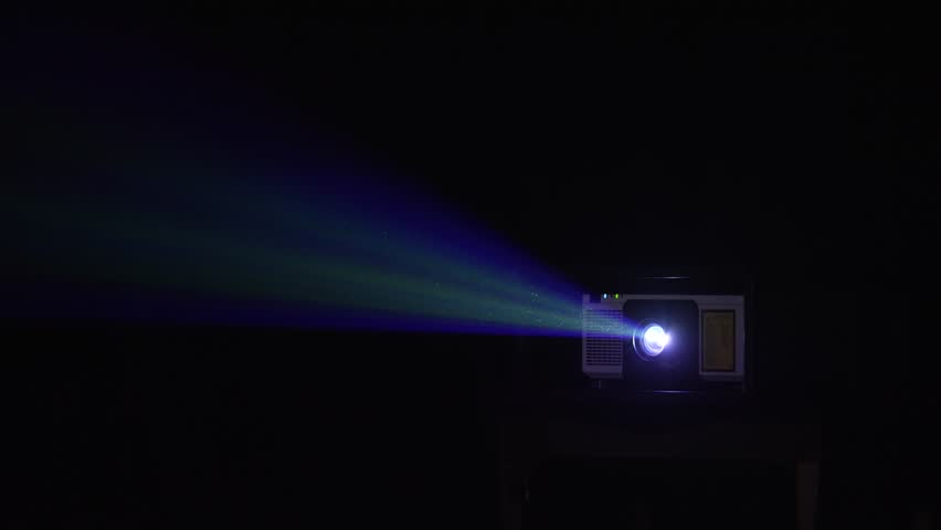  Projector lighting up the dark. A vintage projector illuminates the dark, creating a magical atmosphere perfect for film lovers.  Illuminating swirling dust particles, cinematic noir aesthetic.