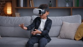 Excited African American child boy enjoying vr gaming ethnic son kid spending leisure at home with virtual reality using hobby overjoyed wearing headset playing 3d game modern technologies play online - Powered by Shutterstock - Get 15% off with code: PIKWIZARD15