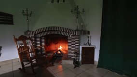 A wooden rocking chair gently sways in front of a fireplace, creating a cozy winter atmosphere filled with warmth and comfort. - Powered by Shutterstock - Get 15% off with code: PIKWIZARD15