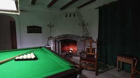 A wooden rocking chair gently sways in front of a warm fireplace inside a billiard room, creating a relaxing and nostalgic atmosphere of comfort and timeless style. - Powered by Shutterstock - Get 15% off with code: PIKWIZARD15