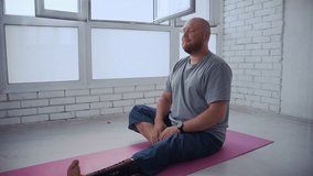 Young man with a prosthetic leg performing stretching exercises on a yoga mat during his morning workout - Powered by Shutterstock - Get 15% off with code: PIKWIZARD15