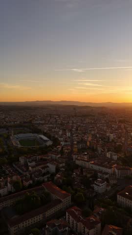 Cinematic drone sunset view over Florence rooftops, golden hour light casting warm glow on red terracotta roofs, panoramic urban landscape, aerial perspective, Italy cityscape