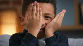 Little boy African American ethnic kid close face with hands palms happy laughing child son boy playing peek a boo game peek-a-boo play hide and seek joyful smiling at home laugh fun fooling around - Powered by Shutterstock - Get 15% off with code: PIKWIZARD15