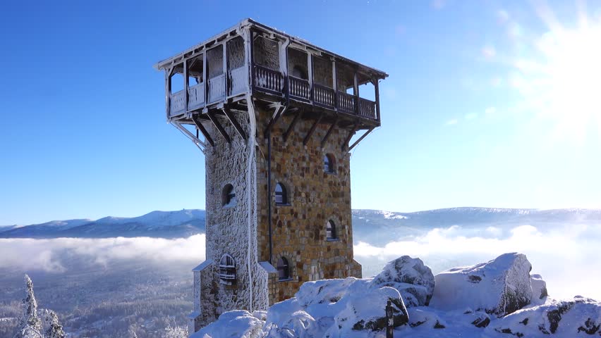 view of Szklarska Poreba in clouds. snow on Wysoki Kamien peak and winter landscape under bright sun. Poland