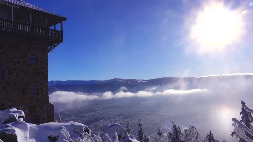 view of Szklarska Poreba in clouds and Krkonose mountains. snow on a High Stone and winter landscape under bright sun. Poland