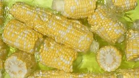 Fresh corn cobs splashing in water top view slow motion - Powered by Shutterstock - Get 15% off with code: PIKWIZARD15