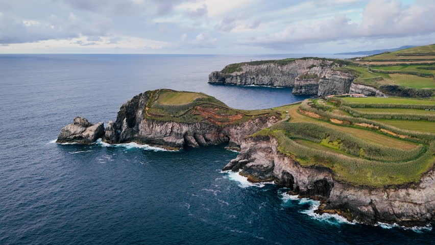 Cliffed coast with narrow inlets and foam lines, Sao Miguel Island, Azores, aerial view. North Atlantic coastal geology