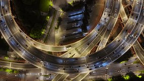 Aerial view of a complex multi-level highway interchange with heavy night traffic and illuminated roads in Shanghai, China. - Powered by Shutterstock - Get 15% off with code: PIKWIZARD15