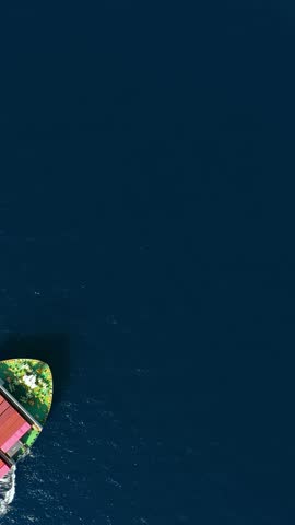 Aerial overhead view of a cargo container ship travling over the ocean as a concept for industry and shipping