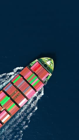 Aerial overhead view of a cargo container ship travling over the ocean as a concept for industry and shipping