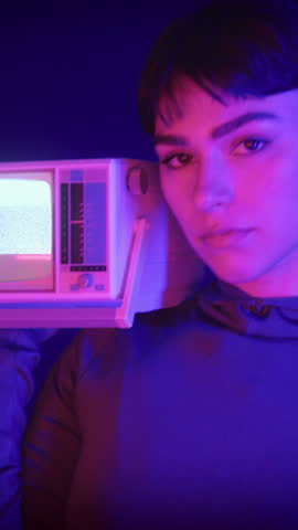 Portrait of Fashionable Female holding Retro Vintage Television, Looking at Camera