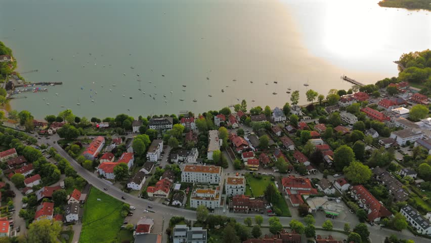 Top view of Herrsching am Ammersee showing lake, harbor, promenade, traditional houses, rural landscape, sunny summer day, water reflections, boating, sailing, scenic view, Europe, Bavarian lake