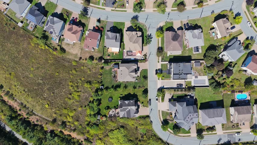 Top View Drone Footage Shows Modern Canadian Neighborhood With Spacious Houses, Clean Streets, Green Lawns, And Tree-Lined Roads In Rural Suburbs Of Halifax, Nova Scotia, Canada.