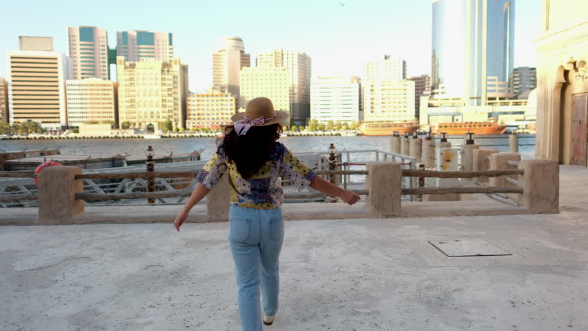 happy woman walking at Al seef Dubai with creek view, Dubai Al seef video ink Pro-resolution