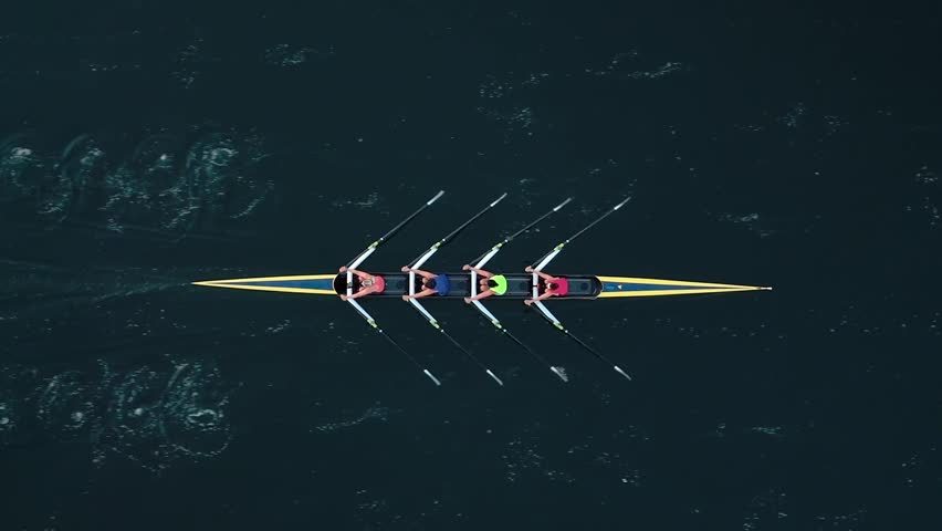 Top View Of Women Rowers In Action At Sunrise, Four Caucasian Women Row Together Across Tranquil Halifax Bay. Drone Captures Their Determination, Fitness, And Connection To Nature In Morning Light.
