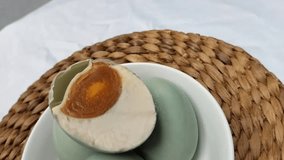 Selective focus. Salted blue duck eggs are placed on a white bowl. Salted duck egg processed food. - Powered by Shutterstock - Get 15% off with code: PIKWIZARD15