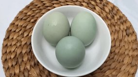 Selective focus. Salted blue duck eggs are placed on a white bowl. Salted duck egg processed food. - Powered by Shutterstock - Get 15% off with code: PIKWIZARD15