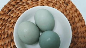 Selective focus. Salted blue duck eggs are placed on a white bowl. Salted duck egg processed food. - Powered by Shutterstock - Get 15% off with code: PIKWIZARD15