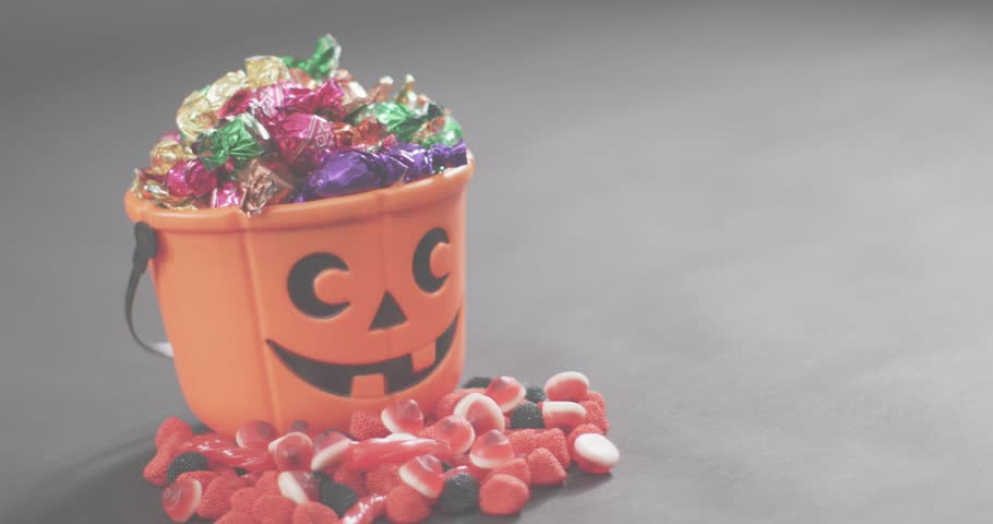 Data visuals fading in over jack-o'-lantern bucket, charts sweeping and pulsing showing metrics. Festive, angular, vibrant, analytical, abstract, seasonal, colorful