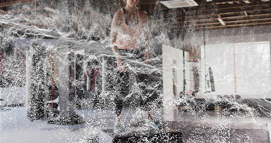 Fitness enthusiast bending knees initiating particle waves then squatting and jumping onto plyo box. Dynamic, movement, strength, endurance, athleticism, motivation, technique