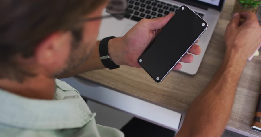 Man picking up device for tech testing while glitching overlays cycling years inspecting finish. Technology, productivity, innovation, digital, modern, workspace, futuristic