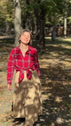 A woman walks in an autumn park