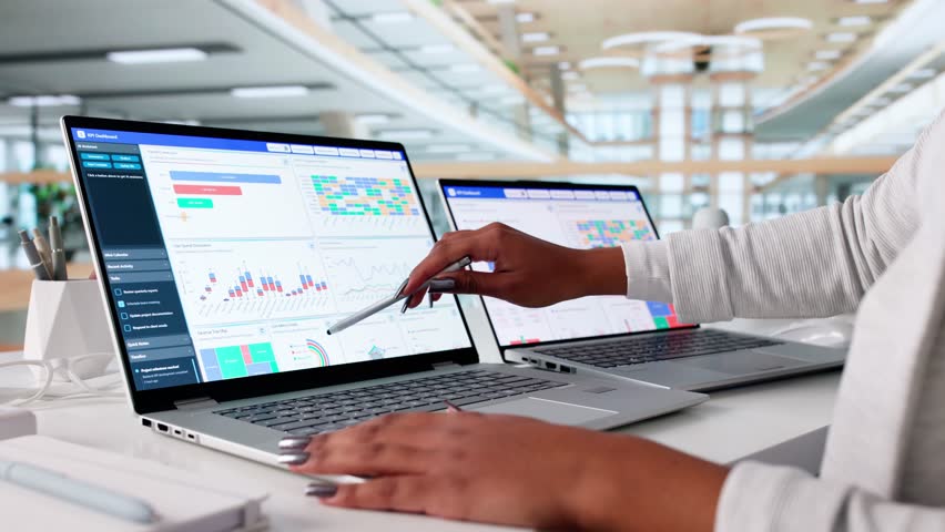 Financial Analyst Using Dashboard With KPI Data On Laptop