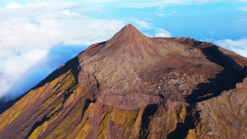 Piquinho, Top of Mount Pico Stratovolcano, Crater and Clouds. Shadow of Mountain. Atlantic Ocean. Pico Island, Azores. Portugal. Aerial View. Drone Moves Backwards