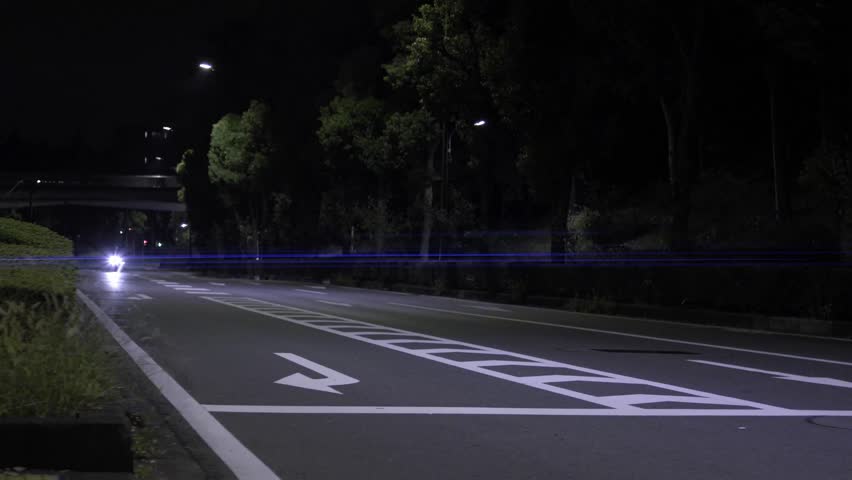 Headlights of running motorbike on a street in Tokyo, Japan