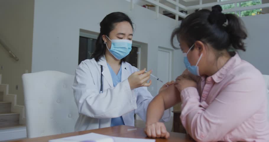 Patient lifting sleeve as medical doctor checking dosage and vaccinating while gauge map animating. Healthcare, vaccination, clinical, medical, immunization, innovation, diagnostic