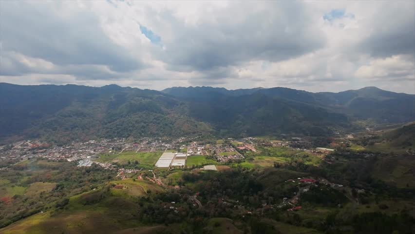 Drone view of Caripe town with houses, farms, and mountains in Venezuela