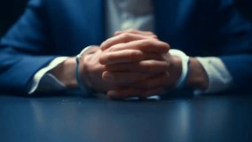 Man in Business Suit with Handcuffed Hands on Table — Corporate Crime, Legal Consequences. - Powered by Shutterstock - Get 15% off with code: PIKWIZARD15
