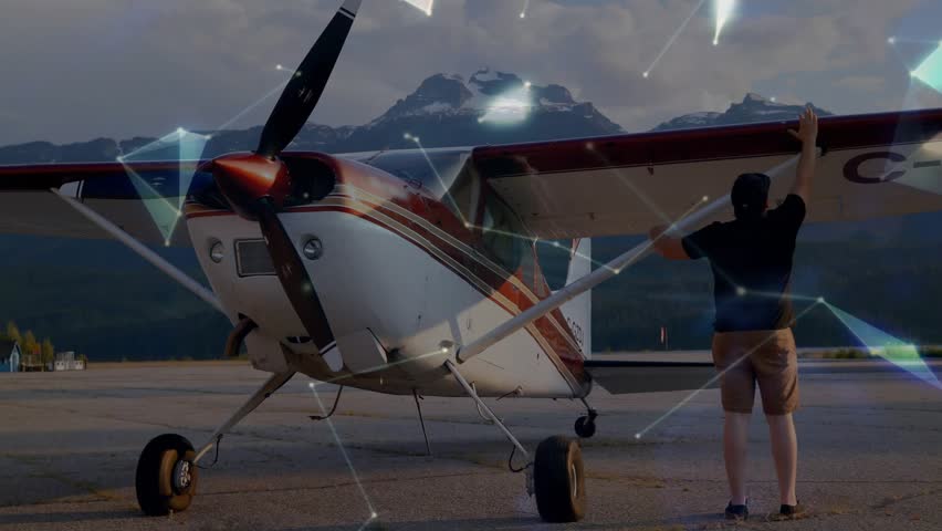 Man performing preflight boarding gripping strut initiating aviation overlay while entering cockpit. Aviation, adventure, travel, aircraft, exploration, technology, transportation
