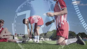 Transparent HUD rotating starting countdown while players stretching hamstrings in soccer training. Athletes, fitness, technology, sportswear, outdoor, teamwork, stamina - Powered by Shutterstock - Get 15% off with code: PIKWIZARD15