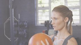 Woman raising orange medicine ball as data charts appear, tracking fitness during overhead presses. Strength, fitness, endurance, determination, motivation, training, performance - Powered by Shutterstock - Get 15% off with code: PIKWIZARD15