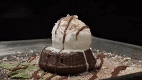 Hot chocolate lava cake topped with vanilla ice cream and chocolate drizzle, 4K macro video. - Powered by Shutterstock - Get 15% off with code: PIKWIZARD15