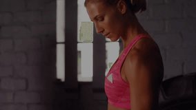 Mid adult female standing with animated graphs fading in, curling dumbbell tracking workout metrics. Strength, fitness, performance, analytics, training, determination, motivation - Powered by Shutterstock - Get 15% off with code: PIKWIZARD15