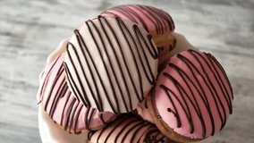 Stack of profiteroles with pink chocolate glaze on marble background, filmed in 4K. - Powered by Shutterstock - Get 15% off with code: PIKWIZARD15