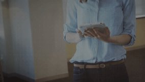 Woman holding tablet in office tapping and swiping while animating bar chart showing data analytics. Data visualization, analytics, business, technology, digital, ui, professional - Powered by Shutterstock - Get 15% off with code: PIKWIZARD15