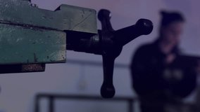 Engineer raising tablet in tech lab updating gauges, world map percentages, inspecting clamped part. Technology, innovation, digital, futuristic, data, analysis, industrial - Powered by Shutterstock - Get 15% off with code: PIKWIZARD15