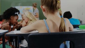 Braided girl writing while glancing at whispering classmates as teacher pointing map crayon border. Education, childhood, collaboration, concentration, learning, classroom, curiosity - Powered by Shutterstock - Get 15% off with code: PIKWIZARD15