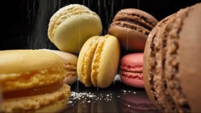 Close-up of colorful macarons dusted with powdered sugar on black background, 4K dessert macro shot.
 - Powered by Shutterstock - Get 15% off with code: PIKWIZARD15