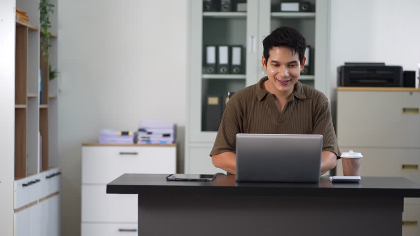 Businessman using laptop computer in office. Happy man, entrepreneur, small business owner working online.	