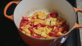 Colorful Sliced Peppers Simmering in an Orange Enamel Dutch Oven	 - Powered by Shutterstock - Get 15% off with code: PIKWIZARD15