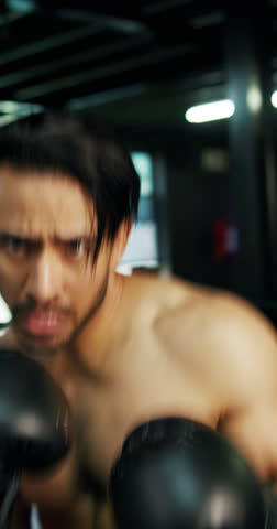 Man, face and fight with boxer in arena for self defense, tournament or sparring match in gym. Portrait, male person or fighter with boxing gloves in POV or ring for punch, challenge or knockout