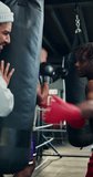 Boxing bag, personal trainer and fitness with men in gym for combat sports, martial arts and workout. Self defense exercise, mma training and punch with people in club for coaching and fight - Powered by Shutterstock - Get 15% off with code: PIKWIZARD15