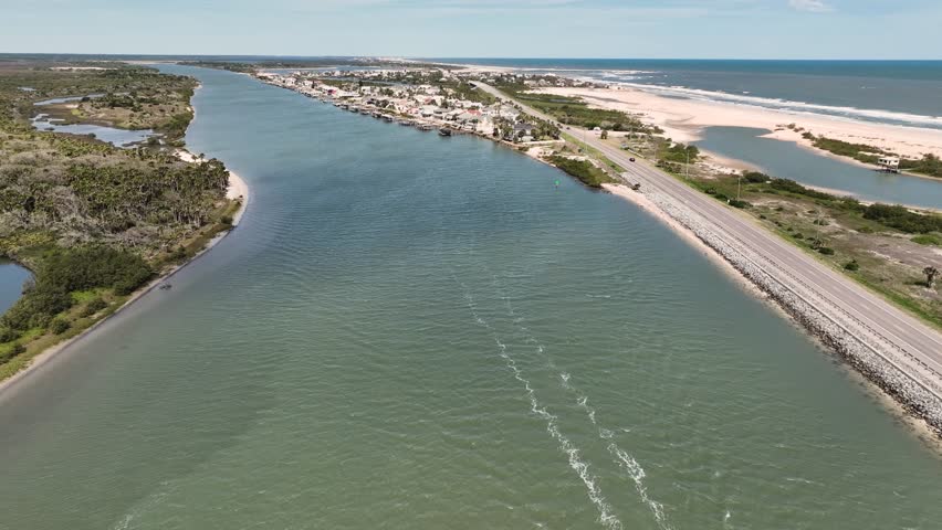 4K aerial drone footage of coastal waterway, sailboat and highway near Ormond Beach, Florida, USA