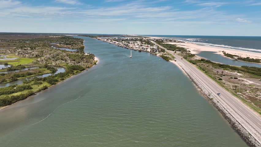 4K aerial drone footage of coastal waterway, sailboat and highway near Ormond Beach, Florida, USA