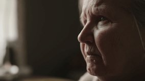 Closeup senior woman sitting indoor with soft window light - Powered by Shutterstock - Get 15% off with code: PIKWIZARD15